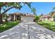 Charming single-story home with a well-maintained lawn and a long driveway leading to a two-car garage at 3505 Kilmer Dr, Plant City, FL 33566
