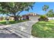 Inviting single-story home with a spacious front yard and a long driveway, shaded by mature trees at 3505 Kilmer Dr, Plant City, FL 33566