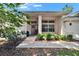 Charming front entrance with decorative wreath, large windows, and lush landscaping at 3505 Kilmer Dr, Plant City, FL 33566