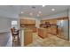Modern kitchen featuring granite countertops, wooden cabinets, stainless steel appliances, and tiled floors at 3505 Kilmer Dr, Plant City, FL 33566
