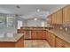 A well-designed kitchen featuring granite countertops, stainless steel appliances, and tiled floors at 3505 Kilmer Dr, Plant City, FL 33566