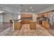 Spacious kitchen featuring wood cabinets, granite countertops, stainless steel appliances and central island at 3505 Kilmer Dr, Plant City, FL 33566