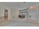 Bright living room with neutral carpet, front door, and dining area with modern chandelier at 3505 Kilmer Dr, Plant City, FL 33566
