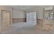 Spacious living room featuring neutral carpet, and sliding glass doors for seamless indoor-outdoor living at 3505 Kilmer Dr, Plant City, FL 33566