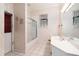 Bathroom featuring a shower-tub combo, sink and vanity, and tiled floor and patterned wallpaper at 3545 E Lake Dr, Land O Lakes, FL 34639