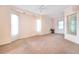 Spacious bedroom with carpet flooring, ceiling fan, and multiple windows for natural light at 3545 E Lake Dr, Land O Lakes, FL 34639