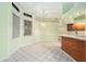 Bright breakfast nook with tile flooring, large windows, and a seamless transition to the kitchen at 3545 E Lake Dr, Land O Lakes, FL 34639