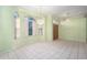 Bright dining area with large windows, a chandelier, tile flooring, and seamless access to the entryway at 3545 E Lake Dr, Land O Lakes, FL 34639
