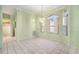 Elegant dining room with an elegant chandelier and light green walls at 3545 E Lake Dr, Land O Lakes, FL 34639