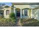 Inviting home entrance with a pathway, pillars, decorative windows and landscaping at 3545 E Lake Dr, Land O Lakes, FL 34639