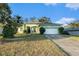 Charming single-story home with a well-manicured lawn and attached two-car garage at 3545 E Lake Dr, Land O Lakes, FL 34639