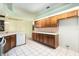 Modern kitchen showcasing wood cabinets, tile backsplash, and stainless steel appliances at 3545 E Lake Dr, Land O Lakes, FL 34639