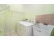 Laundry room with washer and dryer, utility sink, tiled floor and wire rack shelving at 3545 E Lake Dr, Land O Lakes, FL 34639