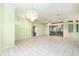 Bright and spacious living room featuring tile floors, a chandelier and sliding glass doors at 3545 E Lake Dr, Land O Lakes, FL 34639