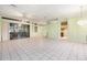 An expansive living room featuring tile floors and sliding glass doors to the lanai at 3545 E Lake Dr, Land O Lakes, FL 34639