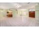 Open-concept living room featuring tile floors, natural light, and a seamless flow to the kitchen at 3545 E Lake Dr, Land O Lakes, FL 34639