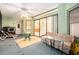 Enclosed sunroom with a ceiling fan, tile floor, and view to the kitchen through sliding glass doors at 3545 E Lake Dr, Land O Lakes, FL 34639