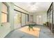 Spacious sunroom with multiple windows and sliding doors, ceiling fan and tiled flooring at 3545 E Lake Dr, Land O Lakes, FL 34639
