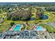 An aerial view of the community showing two pools, clubhouse, golf course, ponds and surrounding trees at 3681 Trophy Blvd # 6, New Port Richey, FL 34655