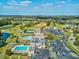 Beautiful aerial view of the community amenities including a golf course, pool, tennis courts, and ample parking at 3681 Trophy Blvd # 6, New Port Richey, FL 34655