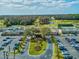 Expansive aerial view of the community clubhouse, pool, golf course and tennis courts in a lush setting at 3681 Trophy Blvd # 6, New Port Richey, FL 34655