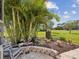 Relaxing back patio with garden views, lush landscaping and charming seating arrangement at 3681 Trophy Blvd # 6, New Port Richey, FL 34655