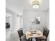 Bright dining area shows lovely pass-through window into kitchen and view into hallway at 3681 Trophy Blvd # 6, New Port Richey, FL 34655