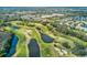Scenic aerial view of the community's lush golf course, featuring serene ponds and tree-lined fairways at 3681 Trophy Blvd # 6, New Port Richey, FL 34655