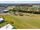 Aerial view of the golf course with a view of the surrounding trees and a glimpse of the nearby buildings at 3681 Trophy Blvd # 6, New Port Richey, FL 34655