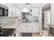 Well-lit kitchen with white cabinets, granite countertops, and modern appliances at 3681 Trophy Blvd # 6, New Port Richey, FL 34655