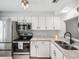 Modern kitchen featuring stainless steel appliances, granite countertops, and ample cabinet space at 3681 Trophy Blvd # 6, New Port Richey, FL 34655