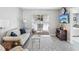 Cozy living room with neutral decor, featuring a sliding glass door leading to the outdoors at 3681 Trophy Blvd # 6, New Port Richey, FL 34655