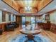 Warm and inviting lobby featuring a central round table, wood paneled walls, and comfortable seating at 3681 Trophy Blvd # 6, New Port Richey, FL 34655
