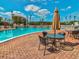 Inviting pool deck with tables, chairs, and umbrellas at 3681 Trophy Blvd # 6, New Port Richey, FL 34655