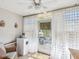 Bright sun room with white curtains, ceiling fan and exit to outdoor patio at 3681 Trophy Blvd # 6, New Port Richey, FL 34655