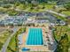 Overhead view of a sparkling swimming pool with lounge chairs and tables for residents to relax and enjoy at 3681 Trophy Blvd # 6, New Port Richey, FL 34655