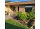 Charming home exterior featuring a small front yard with lush landscaping and a cozy seating area at 38243 Ironwood Pl, Zephyrhills, FL 33542