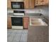 Kitchen features a double basin sink, solid surface countertops, and standard appliances at 38243 Ironwood Pl, Zephyrhills, FL 33542