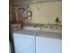 Functional laundry area featuring a washer, dryer, and water heater for added convenience at 38243 Ironwood Pl, Zephyrhills, FL 33542