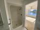 Bathroom featuring a stand-up shower and access to the Primary bedroom with lake views at 4518 Narraganset Trl # 85A, Sarasota, FL 34233