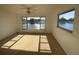 Bright bedroom with carpet, ceiling fan, and serene water views from multiple windows at 4518 Narraganset Trl # 85A, Sarasota, FL 34233