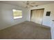 Bright bedroom features a ceiling fan, window for natural light, and closet for storage at 4518 Narraganset Trl # 85A, Sarasota, FL 34233