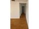 Hallway with wood floors and white walls leading to rooms with closet storage at 4518 Narraganset Trl # 85A, Sarasota, FL 34233