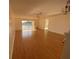 Bright living room with hardwood floors, ceiling fan, and sliding glass doors leading to a water view at 4518 Narraganset Trl # 85A, Sarasota, FL 34233