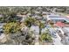 An aerial view that highlights the property's backyard, mature trees, and neighborhood surroundings at 4568 67Th N St, St Petersburg, FL 33709