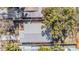 This aerial view showcases the property's roof, landscaping, and proximity to mature trees at 4568 67Th N St, St Petersburg, FL 33709