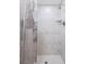 Contemporary bathroom features modern shower with marble-style tile and shower curtain at 4568 67Th N St, St Petersburg, FL 33709