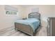 Cozy bedroom with neutral decor, wood-look floors, and comfortable furnishings at 4568 67Th N St, St Petersburg, FL 33709