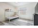 Bedroom with bunk beds, light gray wood-look floors, and natural light at 4568 67Th N St, St Petersburg, FL 33709
