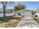Charming home with a well-maintained lawn, driveway, and covered porch at 4568 67Th N St, St Petersburg, FL 33709